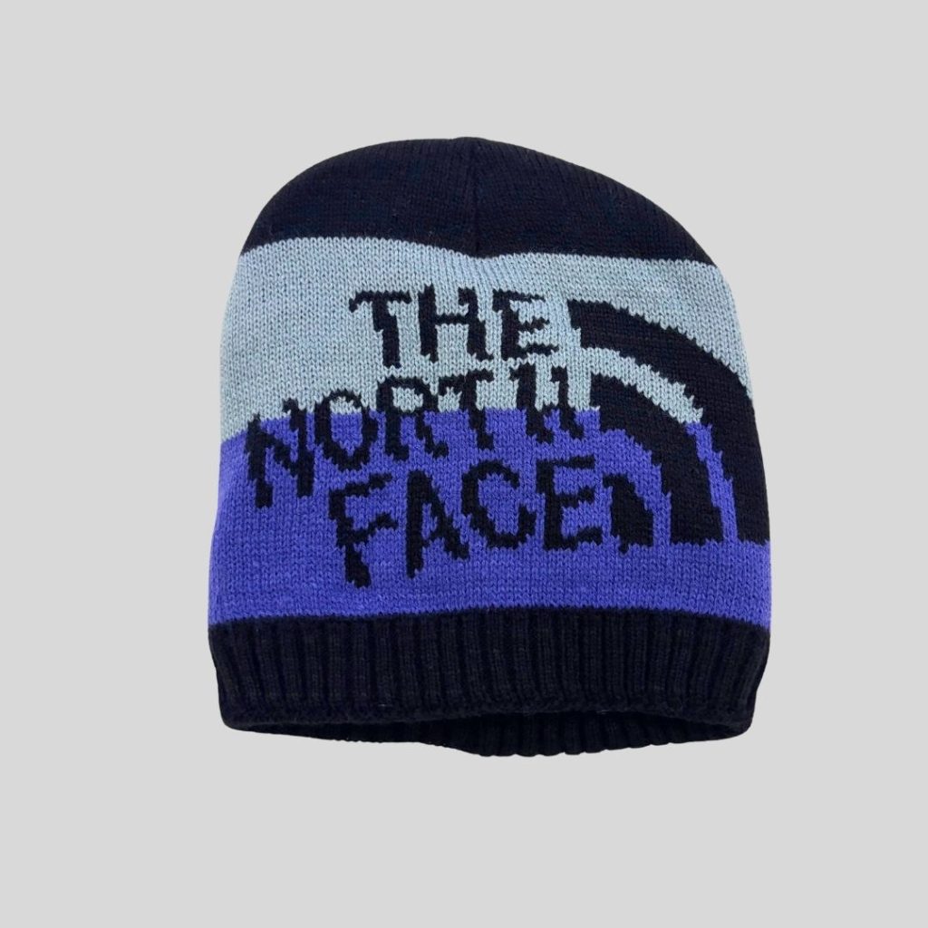 The North Face blue knitted beanie suitable for winter trip
